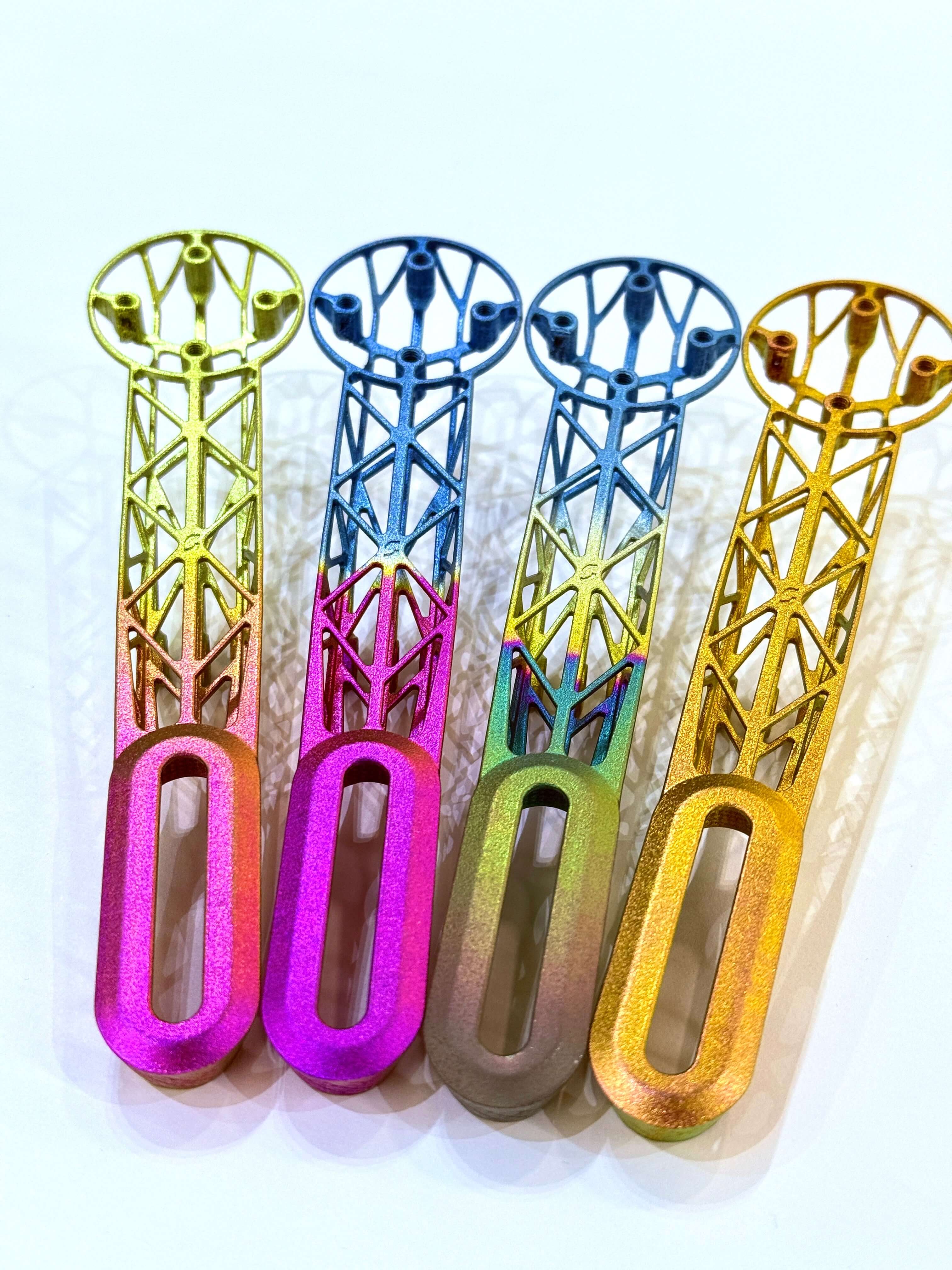 Customize 3D Titanium Bike Computer Mount Color in vibrant hues of gold, pink, blue, and green.